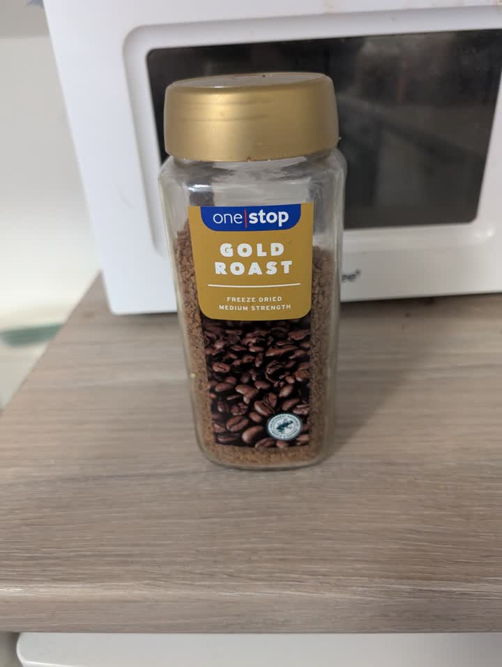 Phone photo of a coffee jar on a kitchen counter
